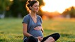 © Mary - Pregnant woman sitting outdoors in a park at sunset