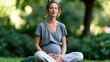 © Mary - Woman meditating outdoors in a green park sitting cross legged