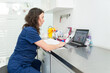 © Nunez Image SL/Stocksy - Veterinarian working on laptop in clinic office