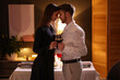 © New Africa - Date. Lovely couple with glasses of red wine at home