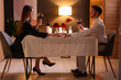 © New Africa - Date. Lovely couple with glasses of red wine at table indoors