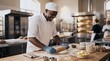 © utaem2022 - Smiling baker rolls dough with rolling pin on wooden counter in professional kitchen