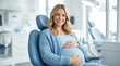 © Masque - A smiling pregnant woman sitting on a dentist chair for maternal dental care.