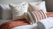 © Selvi - Cozy bedroom arrangement with textured pillows and a rust-colored throw blanket