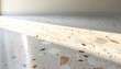 © gilz_r - Modern terrazzo floor tiles low angle wide shot showing polished texture photo with warm sunlight and shadows in a minimal interior room.