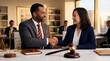 © The Stock Hub - lawyer and client shaking hands in modern office with gavel and scales of justice legal agreement and trust