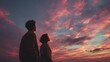 © Nina - Couple silhouetted against vibrant sunset sky with pink and orange clouds. thoughtful contemplatio