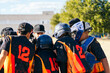 © Koldo_Studio - Youth baseball team players and coach gathering in a huddle, discussing game strategy and teamwork during a practice session