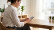 © Николай Срибяник - Woman in white shirt using smartphone at wooden table