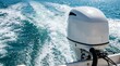 © Design Store - White outboard boat motor operating in turquoise blue ocean water leaving foamy white wake trails on sunny clear day.