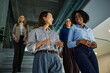 © bernardbodo - Diverse businesswomen walking and discussing in office building