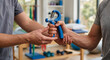 © Stocker Z I - Physical therapist handing a hand grip strengthener to a patient for rehabilitation exercises.