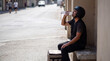 © Emre Akkoyun - Courier resting from work and the summer heat, hydrating with a bottle of water on a city street