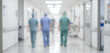 © Vhagar - Two healthcare professionals in scrubs walking down a hospital corridor, creating a sense of teamwork and dedication to patient care in a clinical environment.