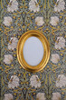 © Westend61 - Oval golden picture frame on wallpaper with Art Nouveau floral design
