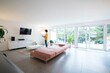 © Westend61 - Woman using laptop in a spacious living room at home