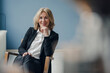 © Westend61 - Portrait of smiling senior businesswoman sitting in chair