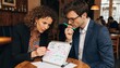 © Ahsan - Two professionals discuss a colorful strategy diagram on a tabletop whiteboard in a cozy cafe, useful for business planning and teamwork promotions.