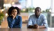 © kinza ali - Diverse couple feeling tension and frustration during conversation at office table with relationship conflict conversation