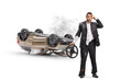 © Ljupco Smokovski - Shocked driver holding a steering wheel next to an overturned car