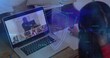 © vectorfusionart - Student writing during laptop class host starting shield overlay pulsing across desk securing data
