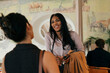 © Maskot - Happy businesswoman having friendly conversation with her colleague at coworking space