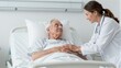 © YiuCheung - Doctor comforts elderly patient in hospital bed with gentle hand and warm smile.
