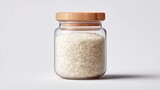 Glass jar filled with white rice and a bamboo lid, isolated on a white background