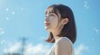 © s - 青空を見上げる爽やかな若いアジア人女性の横顔ポートレート AI generated｜女性、横顔、青空、笑顔、ライフスタイル、希望