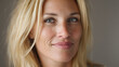 © Milon - Portrait of a middle aged blonde woman looking at the camera with a soft smile portrait caucasian