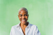 © Westend61 - Portrait of laughing woman in front of green wall