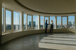 © Westend61 - Colleagues discussing business in an empty office with city skyline