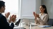 © Lim - Business professionals celebrating success and achievement during a collaborative meeting in a modern office space