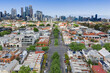 © Gary Chapman/Stocksy - Tree lined streets and high rise buildings of an inner city suburb