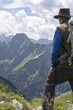 © Walter G. Allgöwer/imageBROKER - Man, 60-70 (model release available) on the Laufbacher-Eckweg with mountain panorama to Höfats, 2259m, Allgäu Alps, Allgäu, Bavaria, Germany