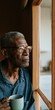 © Andrii Zastrozhnov - Elderly man looking out window with a mug for introspective portrait background and reflective lifestyle imagery