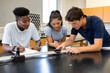 © ultramcu - Students conducting physics experiment in bright classroom lab