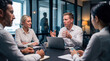 © Athena Studio - Engaging photograph of diverse business professionals in a collaborative meeting in a bright, modern corporate office.