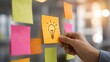 © emwe studio - Agile planning workshop showing a hand attaching a yellow lightbulb sticky note to a glass wall during a brainstorming session.