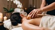 © tangmo.pa - Relaxed woman receiving a hot lava shell massage therapy at a luxury spa