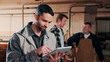 © peopleimages.com - Carpentry, happy and man on tablet in workshop for planning, schedule or manufacturing quote. Warehouse, male person or carpenter with technology for woodwork or furniture production with team