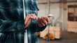 © peopleimages.com - Man, hands and carpenter typing with phone in workshop for online network or shipping order. Male person, carpentry or texting on mobile smartphone for business stock, wood production or distribution