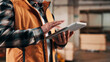 © peopleimages.com - Hands, tablet and scroll in carpentry warehouse, check lumber order or online inventory management. Person, carpenter and tech for digital stock analysis or search woodworking merchandise app