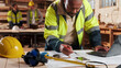 © peopleimages.com - Laptop, man and drawing in warehouse for blueprint, manufacturing and woodwork contractor. Paperwork, production and carpenter person in joinery factory with tech in workshop, draft or project