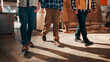 © peopleimages.com - Team, carpentry and legs of men in workshop for wood production, manufacturing and timber supply. Construction, walking and people in warehouse for woodworking, furniture repair and lumber inventory