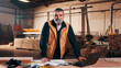 © peopleimages.com - Carpenter, portrait and man on laptop in workshop for planning, schedule or manufacturing quote. Warehouse, mature person or carpentry with tech for woodwork or furniture production with smile