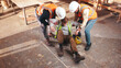 © peopleimages.com - Carpenter, help and man with injury in factory, safety failure and muscle tension on floor and above. Workplace, accident and person with joint pain, woodworking and colleague support in workshop