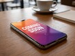 © Junaid - Smartphone with coming soon screen, mobile phone on wooden table, cup of coffee and notebook