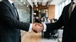 © Faisal - Diverse businessmen shaking hands in a modern office, closing a successful business deal.