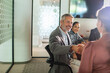 © Marko Geber - Business colleagues shake hands in modern office meeting room